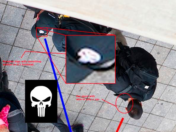 Craft mercenaries on the scene at the Boston Marathon, their hats bearing the company's logo, magnified here